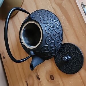 Black cast iron teapot with infuser basket